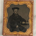 Lot 114 - Antique Matted Tintype Photograph Behind Glass Of Young Man In Peacoat With Beret Hat, Books On Table