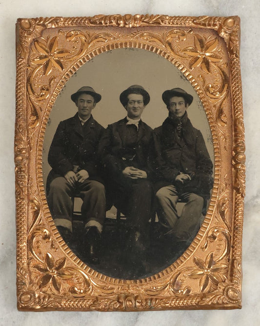 Lot 117 - Antique Larger Size, Approximately 1/4 Plate Matted Tintype Photograph Of Three Young Men In Hats, Middle Man Smiling
