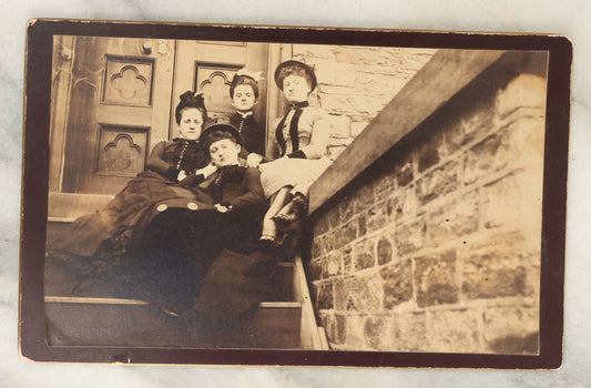 Lot 121 - Antique Long Cabinet Card Photograph Of Four Well Dressed Women Sitting On Front Stoop Steps In Front Of A Door With Interesting Perspective, Brick Wall In Foreground, Low Angle