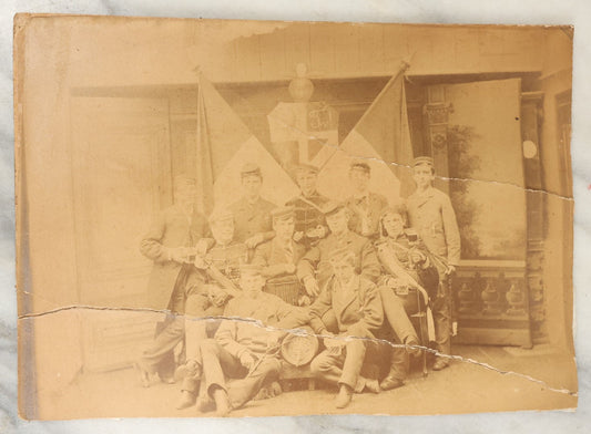 Lot 126 - Antique Boarded Group Photo, Very Poor Condition, Many Losses And Breaks, Of A German Fraternal Or Military Organization, With Many Flags And Regalia, Men Holding Mugs Of Beer (Note Man From Lot 123, Left Side Middle Row)