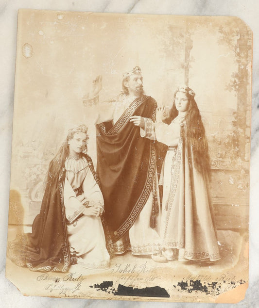 Lot 128 - Antique Boarded Photo Of Three Actors, Two Women And One Man, In Costume, Names Written In Pen, Illegible, Possible Surname Rutz, Note Wear, Poor Condition