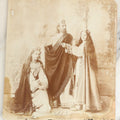Lot 128 - Antique Boarded Photo Of Three Actors, Two Women And One Man, In Costume, Names Written In Pen, Illegible, Possible Surname Rutz, Note Wear, Poor Condition