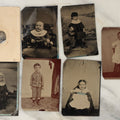Lot 131 - Grouping Of Seven Antique Tintype Photographs Of Babies And Children, Including Smiling Baby With Tinted Yellow Waist Ribbon, Toddler In Winter Clothes With Gloves, And More