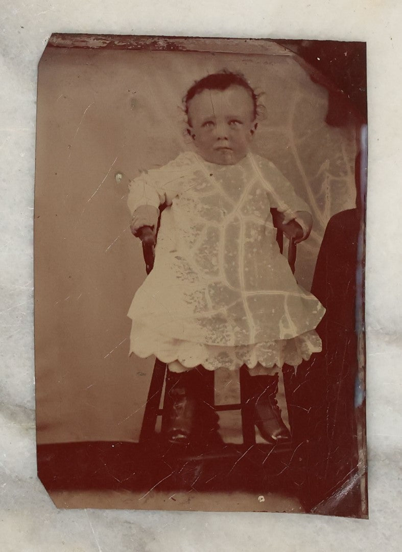 Lot 131 - Grouping Of Seven Antique Tintype Photographs Of Babies And Children, Including Smiling Baby With Tinted Yellow Waist Ribbon, Toddler In Winter Clothes With Gloves, And More