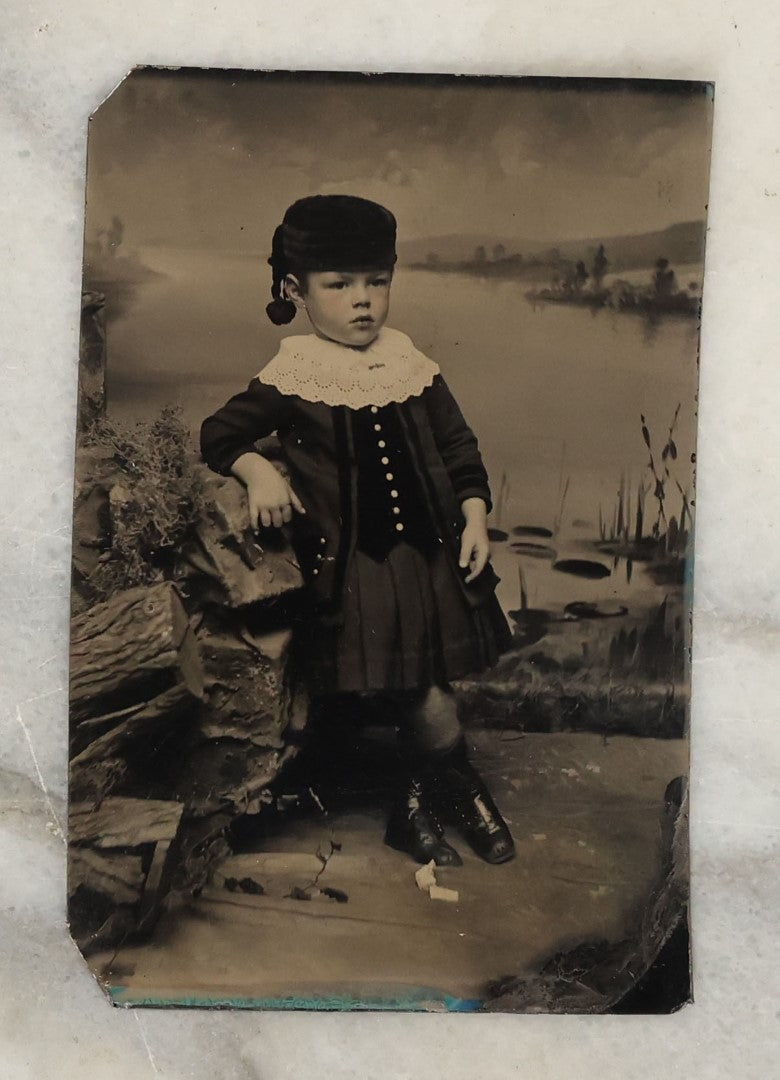 Lot 131 - Grouping Of Seven Antique Tintype Photographs Of Babies And Children, Including Smiling Baby With Tinted Yellow Waist Ribbon, Toddler In Winter Clothes With Gloves, And More