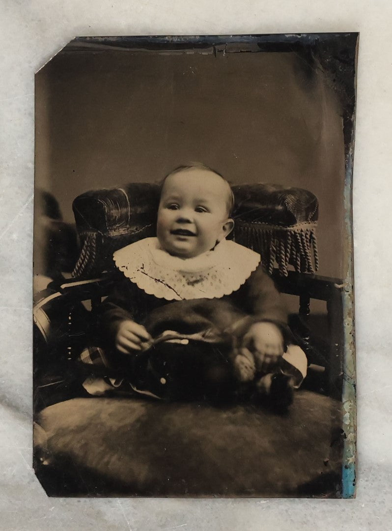 Lot 131 - Grouping Of Seven Antique Tintype Photographs Of Babies And Children, Including Smiling Baby With Tinted Yellow Waist Ribbon, Toddler In Winter Clothes With Gloves, And More