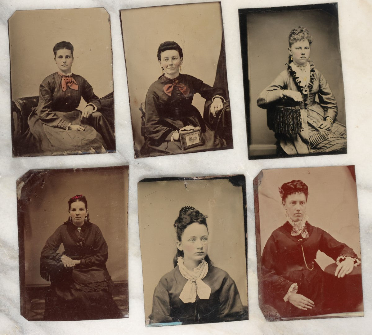 Lot 135 - Grouping Of Six Antique Tintype Photographs Of Pretty Young Women, Including Smiling Woman With Tinted Bow Holding Photo Album