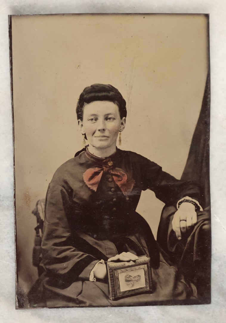 Lot 135 - Grouping Of Six Antique Tintype Photographs Of Pretty Young Women, Including Smiling Woman With Tinted Bow Holding Photo Album