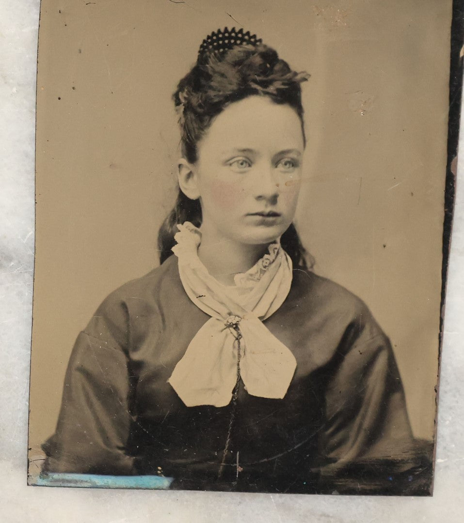 Lot 135 - Grouping Of Six Antique Tintype Photographs Of Pretty Young Women, Including Smiling Woman With Tinted Bow Holding Photo Album
