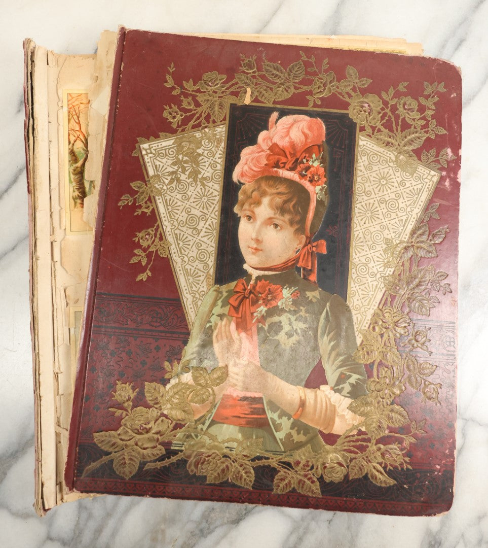 Lot 155 - Antique Victorian Scrapbook Album With Woman On Cover Containing 175+ Pieces Including Die Cuts, Trade Cards, Calling Cards, And More, With Woman On Cover, Note Cover Detached