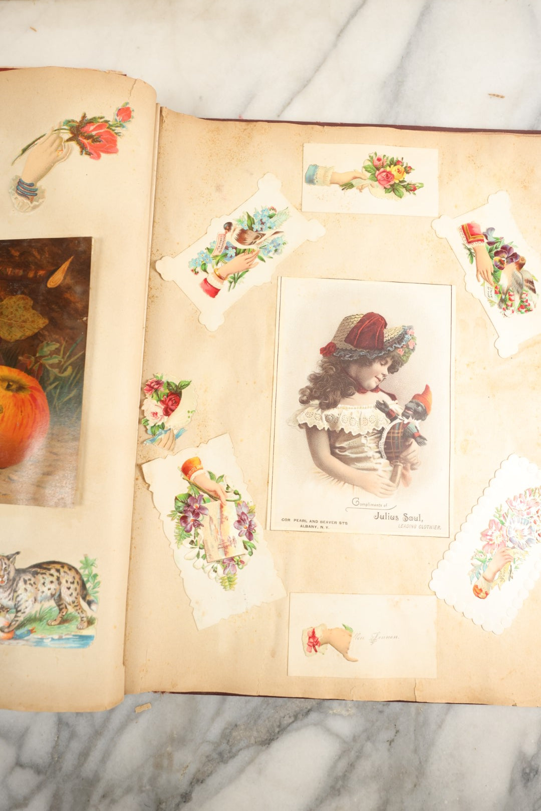 Lot 155 - Antique Victorian Scrapbook Album With Woman On Cover Containing 175+ Pieces Including Die Cuts, Trade Cards, Calling Cards, And More, With Woman On Cover, Note Cover Detached