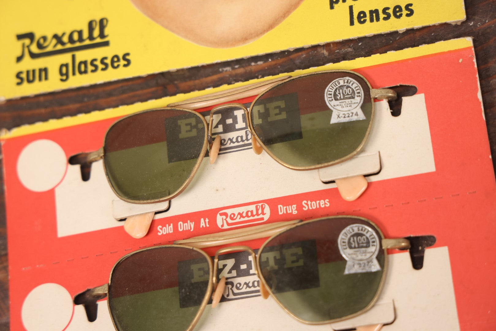 Lot 036 - Vintage Rexall Sunglasses Carded Store Display With Woman's Face, Four Pairs Of New Old Stock N.O.S. Sunglasses With Protective Lenses, Note Separation In Cards