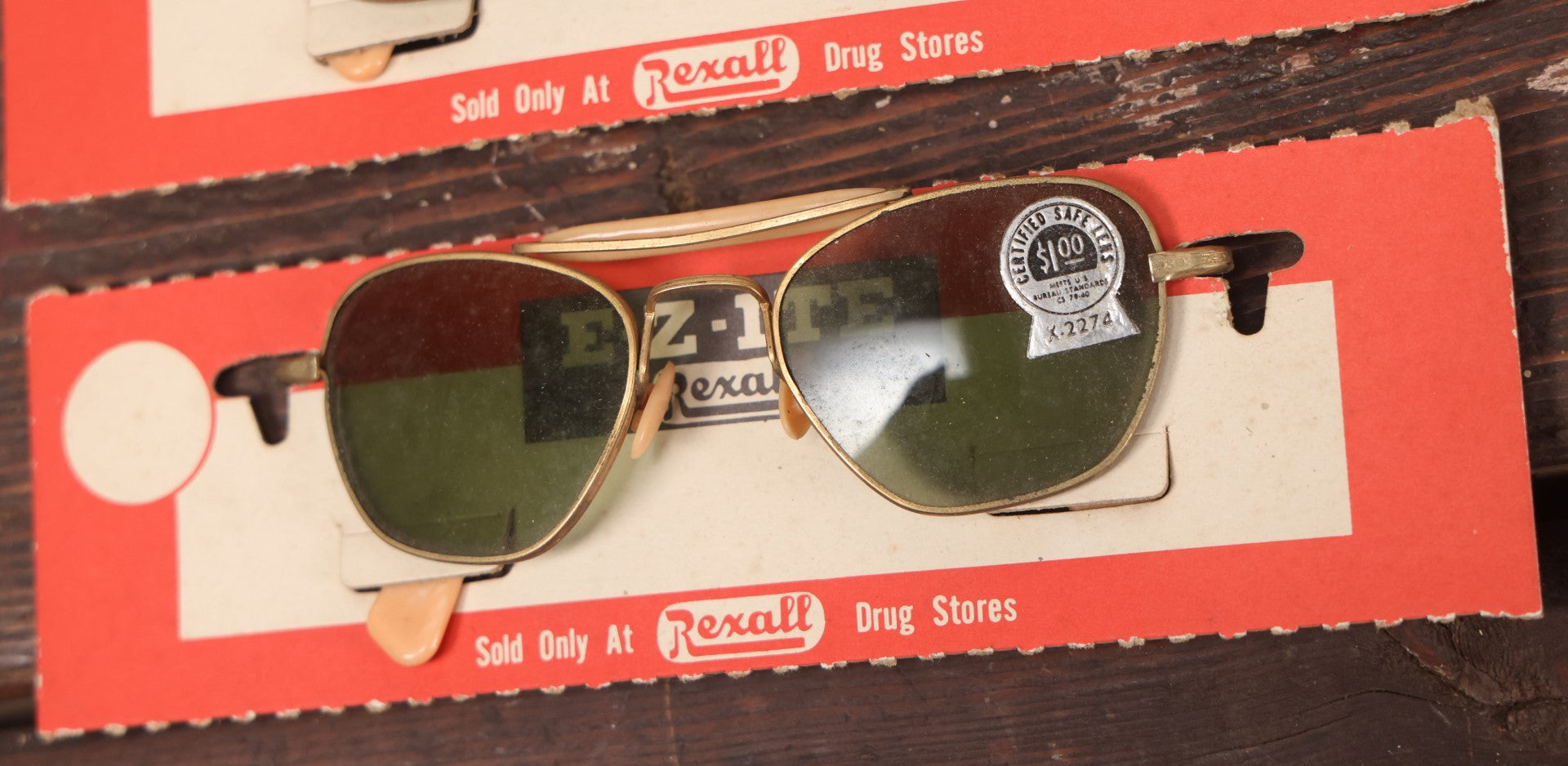 Lot 036 - Vintage Rexall Sunglasses Carded Store Display With Woman's Face, Four Pairs Of New Old Stock N.O.S. Sunglasses With Protective Lenses, Note Separation In Cards