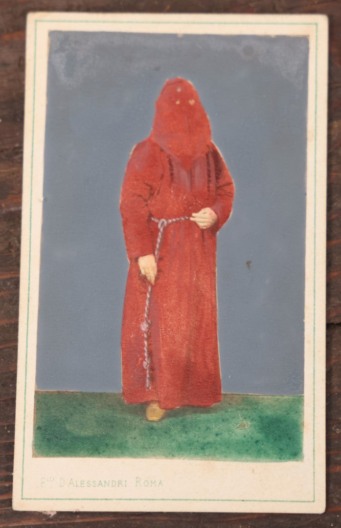 Lot 040 - Antique Hand Colored Carte De Visite C.D.V. Photograph Of An Italian Priest Of The Confraternity Of The Penitents (Penitents Rouges Or Red Penitents), Catholic Religious Order, Fratelli D'Alessandri Photographer