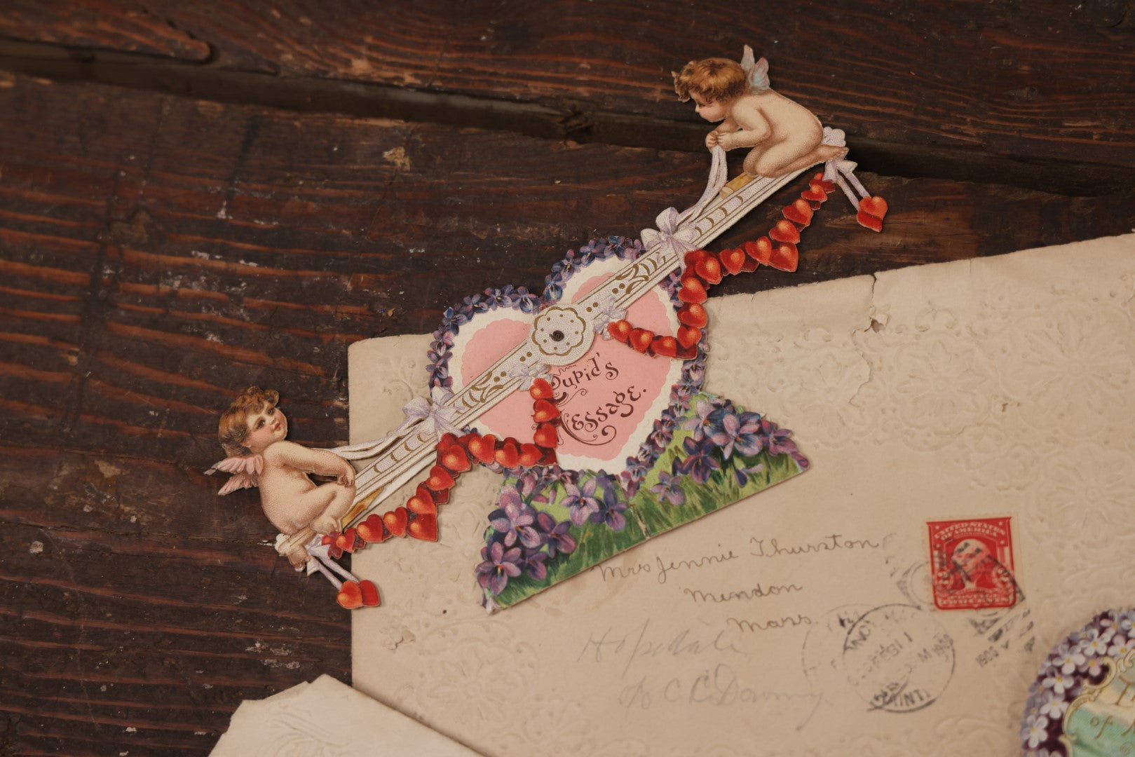 Lot 062 - Grouping Of 3+ Valentines Ephemera With Antique Die Cut Valentines, Including Mechanical Cupid On Seesaw Valentine, And Embossed Envelope