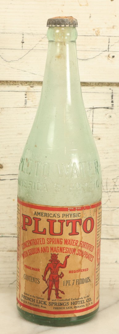 Lot 005 - Antique Pluto Water Glass Bottle With Original Paper Label, Devil Graphics, French Lick Springs Hotel Co., French Lick, Indiana, With Embossed Devil On Bottom, Drilled Cap