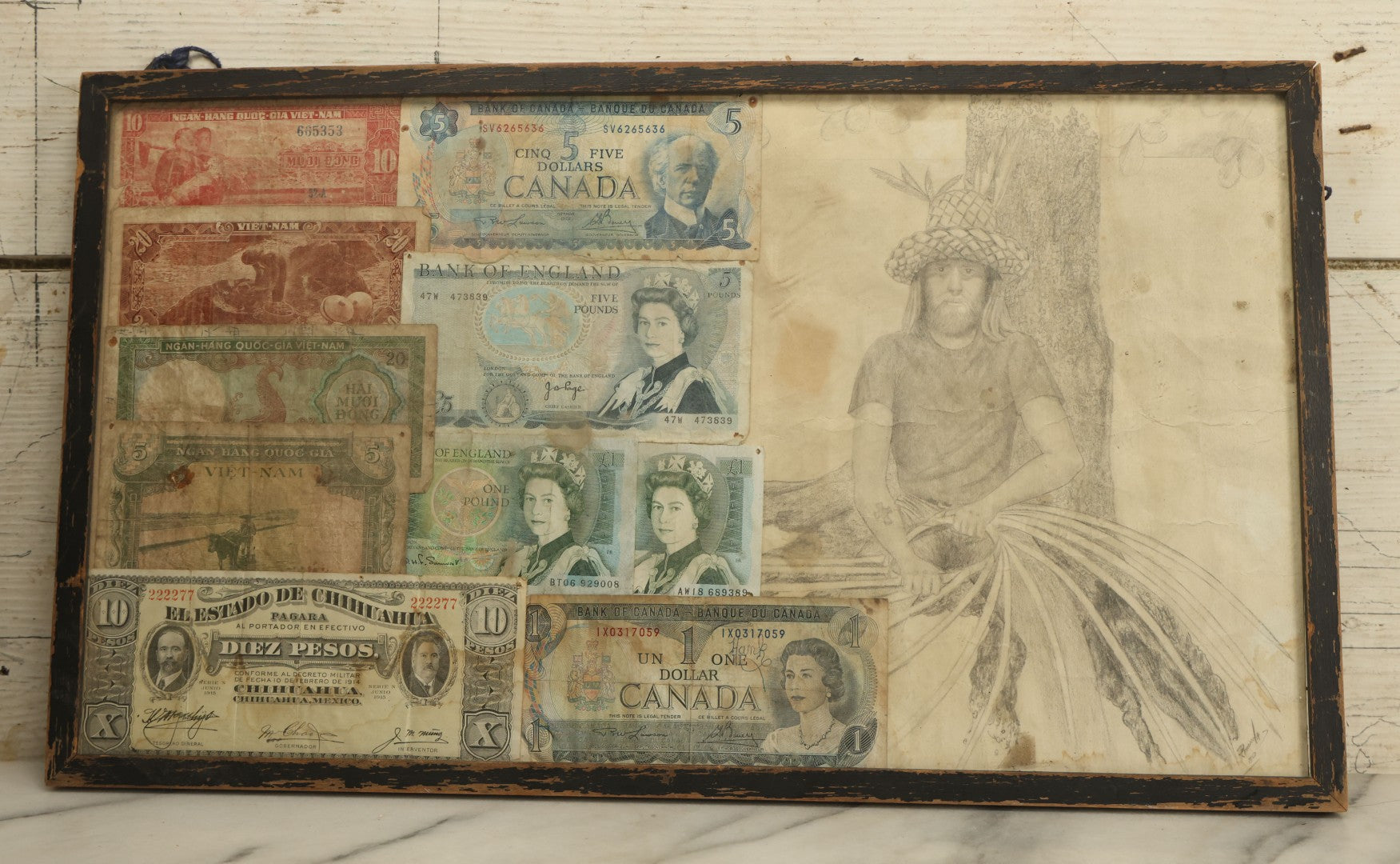 Lot 043 - Vintage Pencil Sketch Folk Art Of Man Weaving Hat With Nine Pieces Of Foreign Currency In Frame From Canada, Vietnam, Etc., Artist Signed And Dated, Illegible