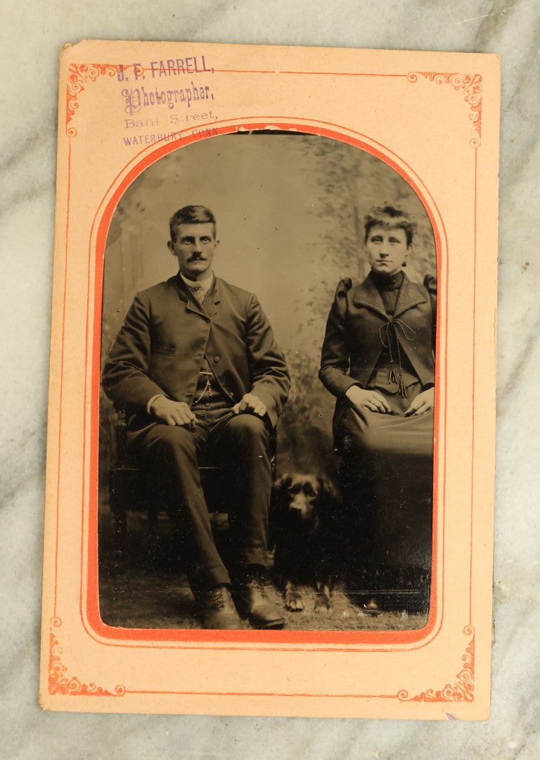 Lot 066 - Antique 1/4 Plate Tintype Photograph Of A Couple And Their Black Dog, Dog Sitting Between Man And Woman, J.F. Farrell Photographer, Waterbury, Connecticut