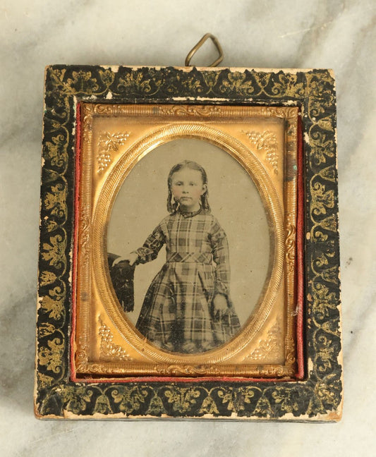 Lot 072 - Antique Tintype Photograph Of A Little Girl In A Plaid Dress In A Black Hanging Frame With Gold Painted Decoration