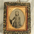 Lot 072 - Antique Tintype Photograph Of A Little Girl In A Plaid Dress In A Black Hanging Frame With Gold Painted Decoration