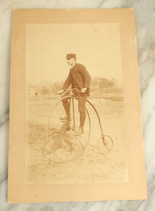 Lot 074 - Antique Boarded Photograph Of A Man In A Cap On A High Wheel Penny Farthing Bicycle