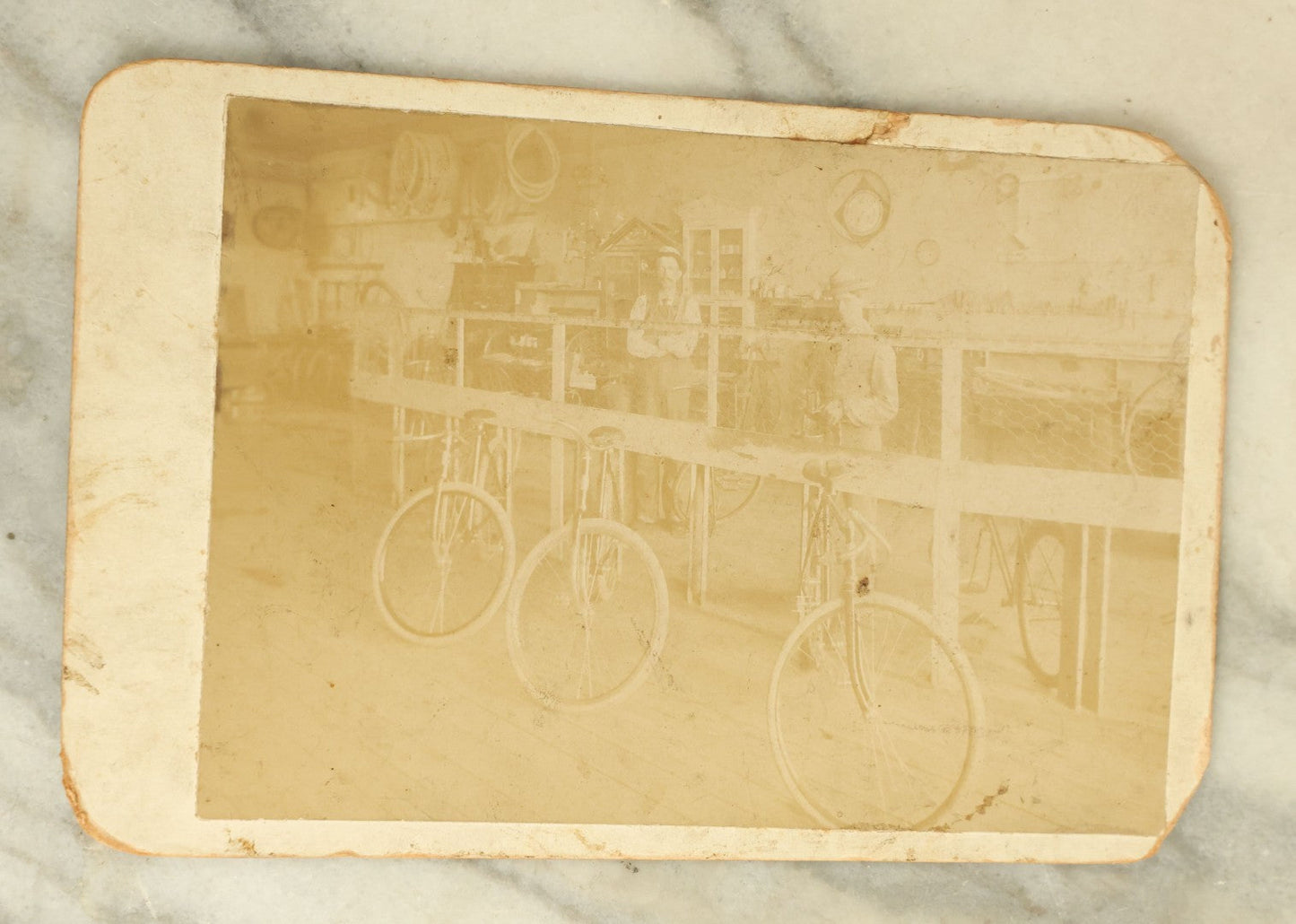 Lot 076 - Antique Cabinet Card Occupational Photograph Of Two Men Working In A Bicycle Shop, Identified On Verso As Frank Bolle's Bike Shop