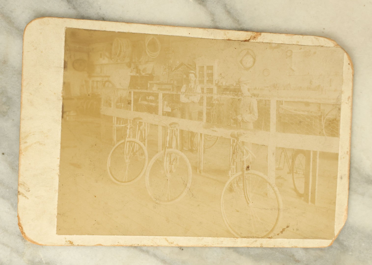 Lot 076 - Antique Cabinet Card Occupational Photograph Of Two Men Working In A Bicycle Shop, Identified On Verso As Frank Bolle's Bike Shop