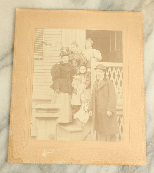 Lot 091 - Antique Boarded Photograph Of A Group Of Four People With A Little Girl And Her Two Dolls