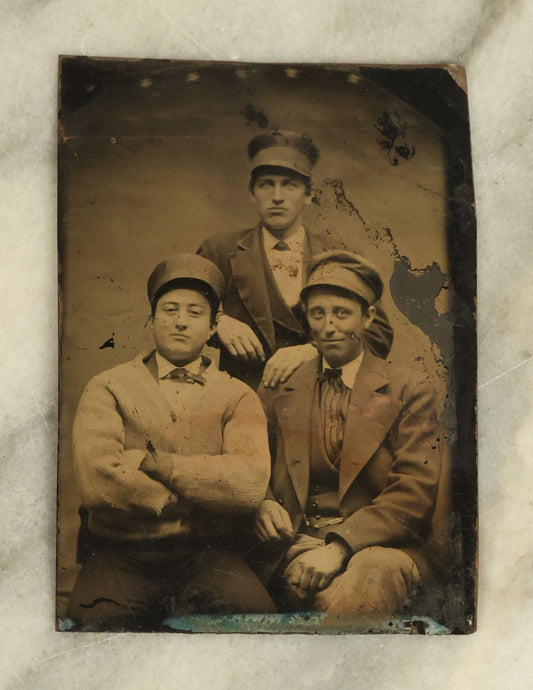 Lot 097 - Single Antique Tintype Photograph Of A Group Of Three Cheeky Young Men In Caps, Smirking