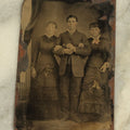 Lot 099 - Single Antique Tintype Photograph Of A Man Linking Arms With Two Ladies