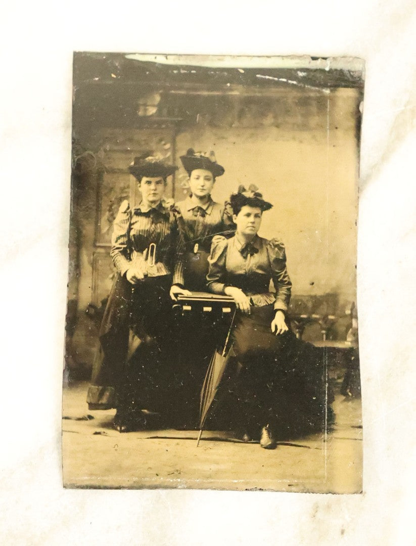 Lot 100 - Grouping Of Nine Antique Tintype Photographs, Mostly Of Groups Of Three Women, With Extravagant Dress