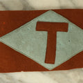 Lot 108 - Antique Reddish Felt Arm Band With Hand Sewn "T" Insignia