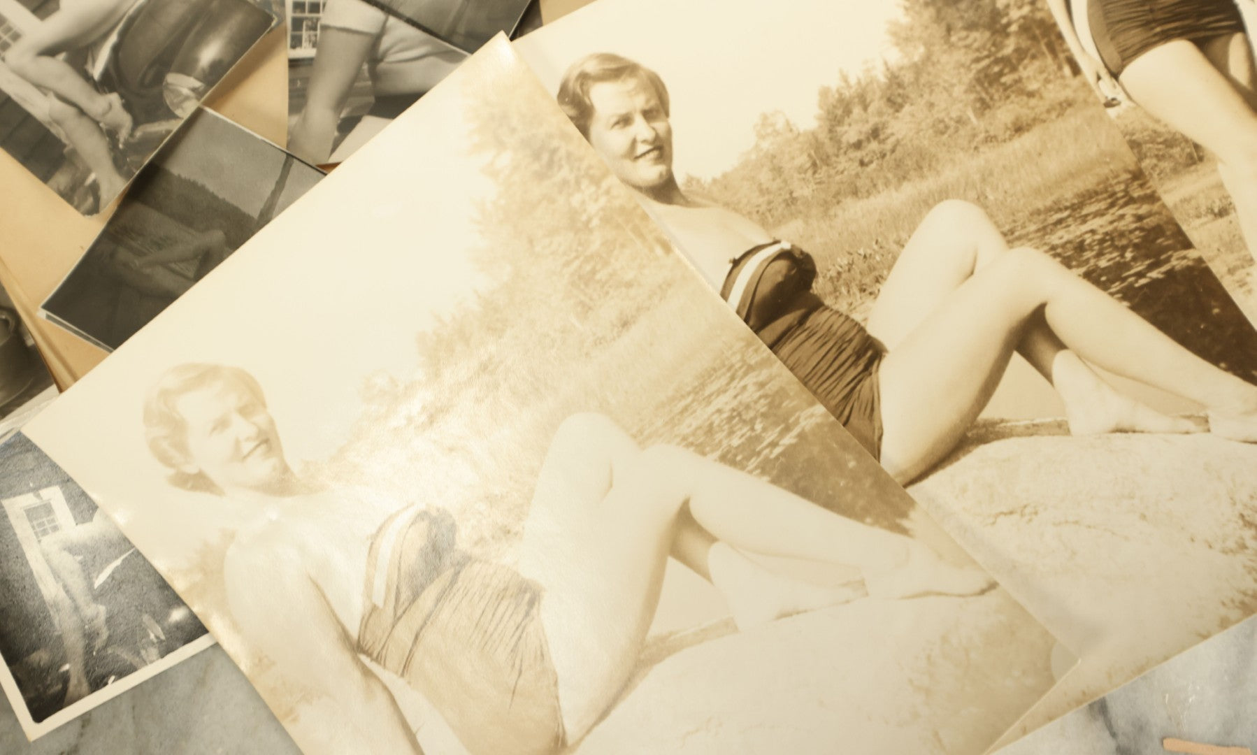 Lot 139 - Grouping Of 20+ Vintage Risque, Sexy Snap Shot Photos Of A Woman In Her Swimsuit, Posing By The Beach, Various Sizes, Circa 1950s