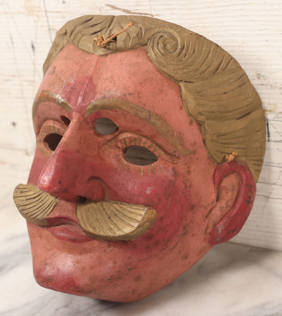 Lot 028 - Vintage Folk Art Mask Of A Blonde Man With A Blonde Mustache, Four Eye Holes, Artist Signed On Verso, With String, 20Th Century