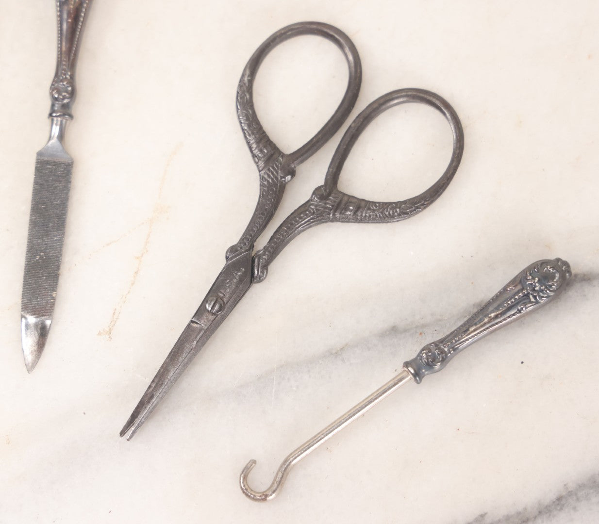 Lot 047 - Antique Sterling Silver Handled Grooming Set With Small Scissors, Button Hook, And File, In Black Leather Case, Marked Sterling, Made In U.S.A.