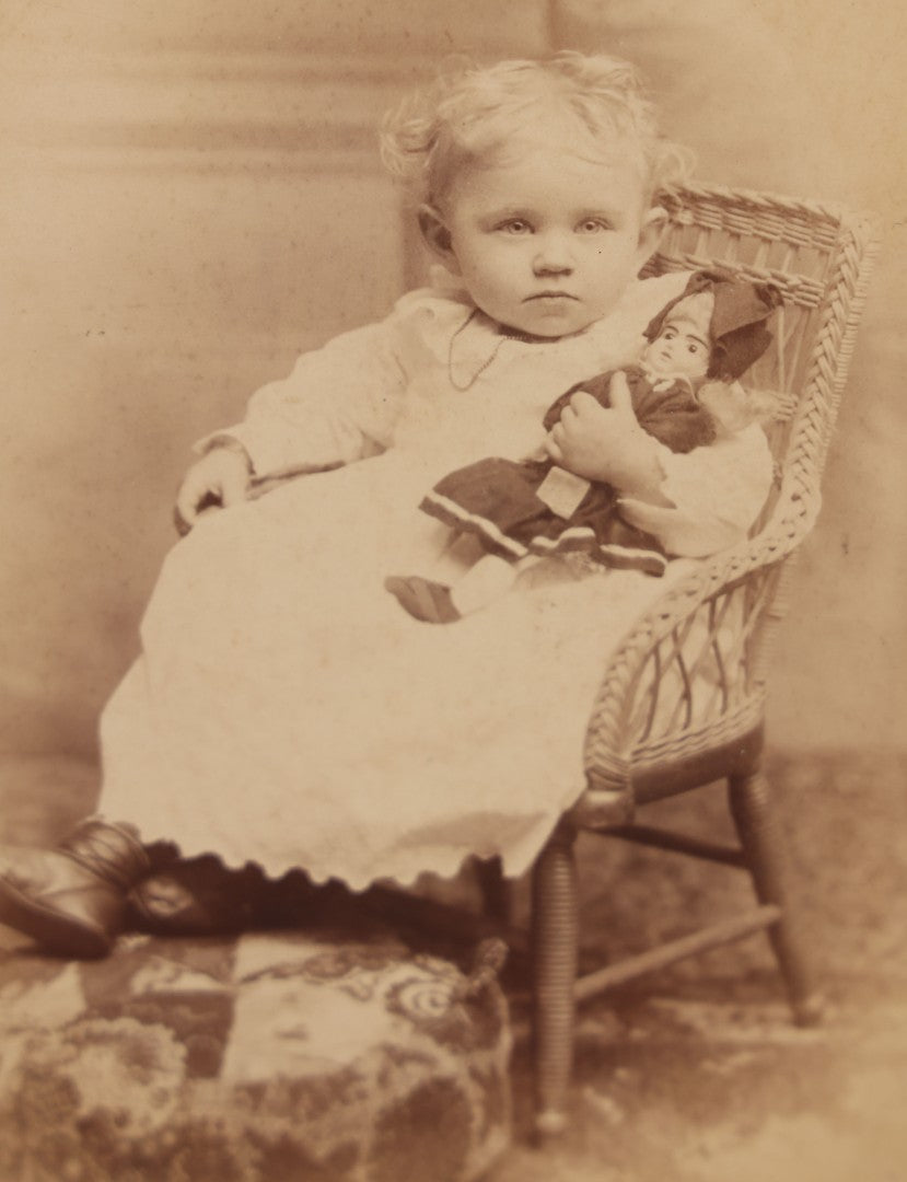 Lot 067 - Antique Cabinet Card Photograph Of A Young Baby Toddler Holding Her Doll, Seated In Chair, Harris & Greene Photographers, Utica, New York