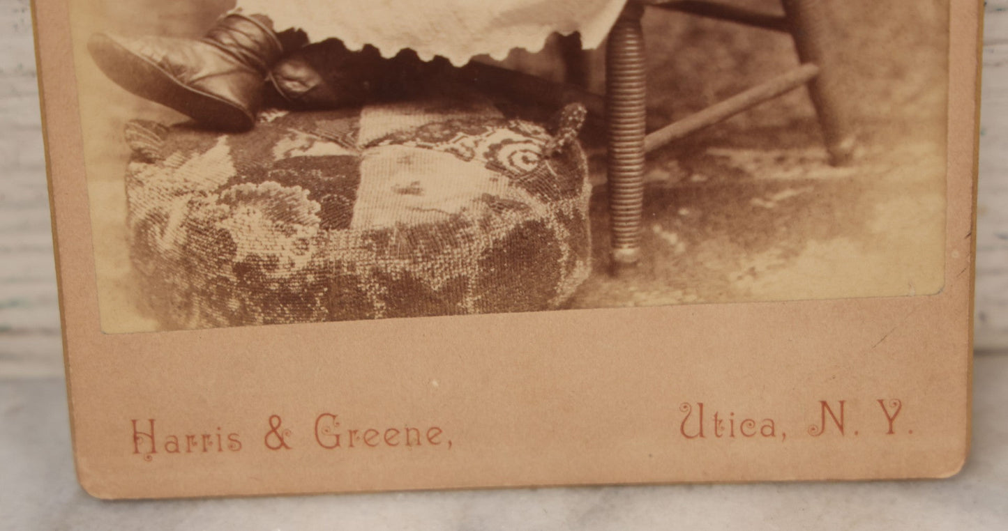 Lot 067 - Antique Cabinet Card Photograph Of A Young Baby Toddler Holding Her Doll, Seated In Chair, Harris & Greene Photographers, Utica, New York