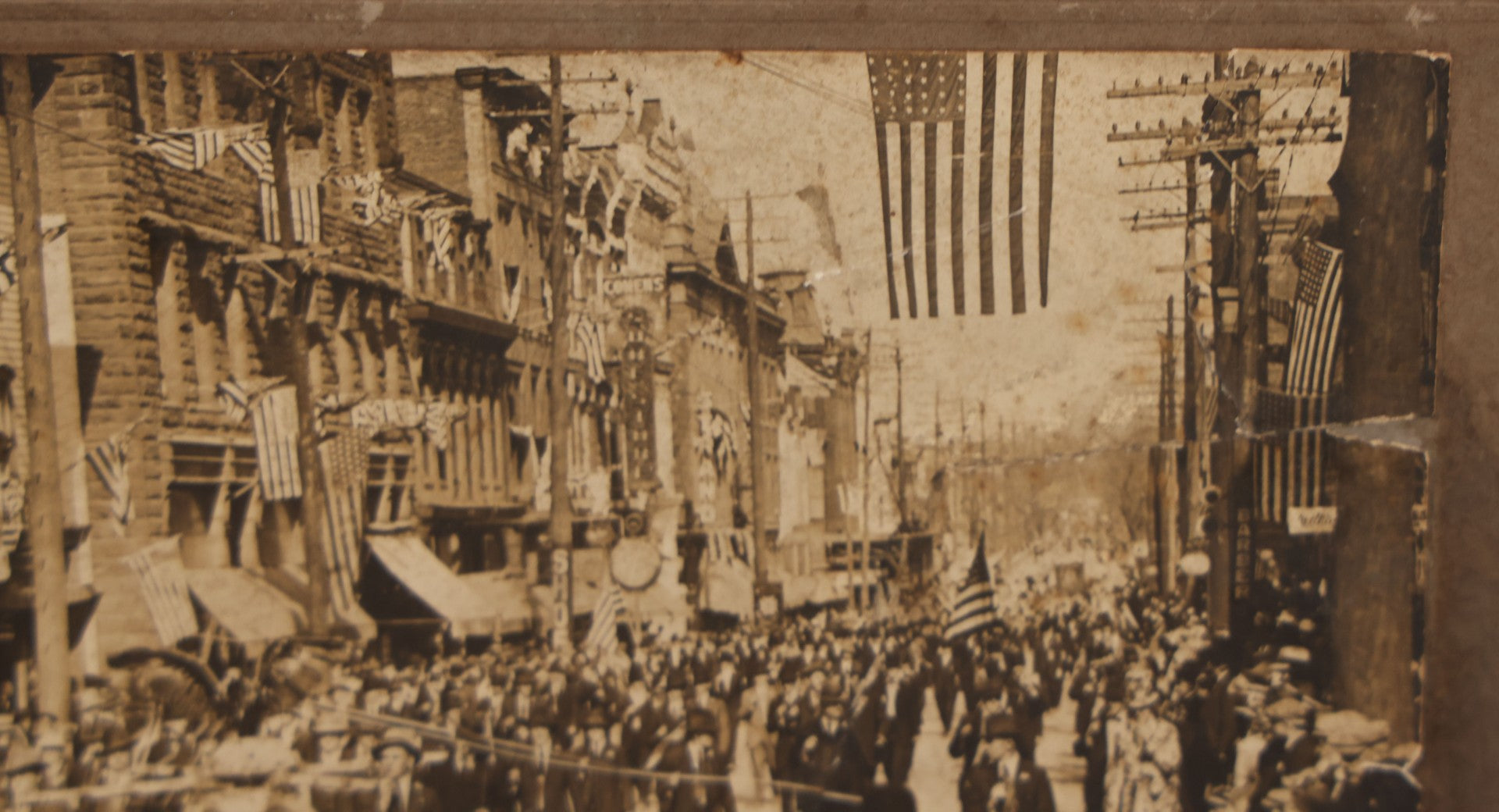 Lot 074 - Antique Boarded Parade Photo On Urban Street With Many 48-Star American Flags, Possible Celebration Of The End Of World War One, Or Other Patriotic Event, Note Loss To Corner, Wear, Harpel Photographer, Lebanon, Pennsylvania