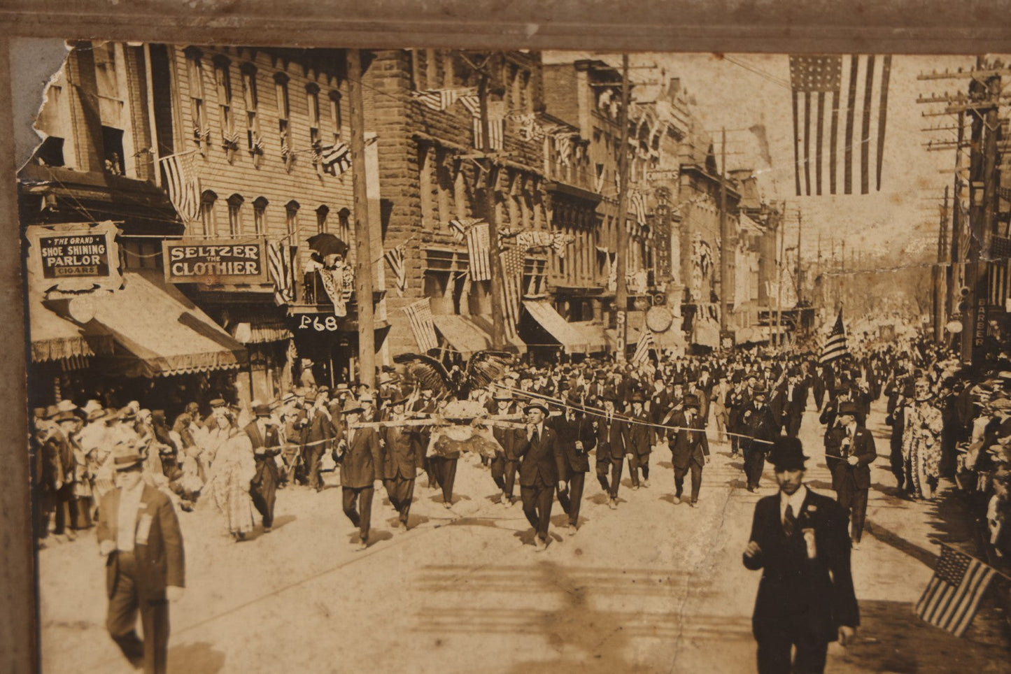 Lot 074 - Antique Boarded Parade Photo On Urban Street With Many 48-Star American Flags, Possible Celebration Of The End Of World War One, Or Other Patriotic Event, Note Loss To Corner, Wear, Harpel Photographer, Lebanon, Pennsylvania