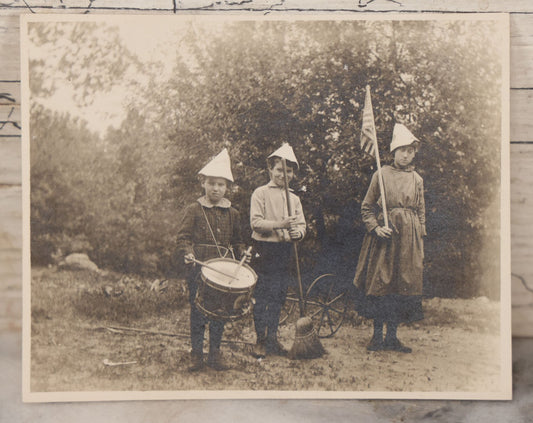 Lot 076 - Antique Snapshot Photograph Of Three Children, Likely On July 4Th, One Holding American Flag, One Holding Broom, The Other Drumming