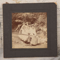 Lot 077 - Antique Boarded Photo Of Five Women In Makeshift Fanciful Flying Machine, Sleigh, Mother Hubbard Dress-Up, Little Boy In Background