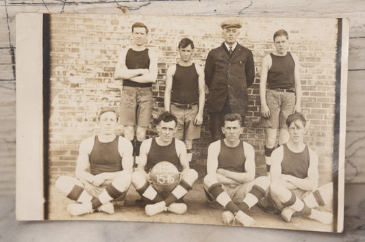 Lot 078 - Antique Real Photo Postcard R.P.P.C. Of An All-Star Men's Basketball Team, 1915-1916 Season, Seven Players With Coach, Unused