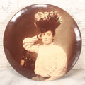 Lot 080 - Antique Celluloid Photo Button Of A Pretty Young Woman With A Colorful Floral Hat, Collins Portraits, Chicago