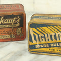 Lot 027 - Pair Of Vintage Automotive Light Bulb Tins With Contents Including Gofkauf's Automotive Stores Of New England, And Lighting Auto Stores Incorporated, As Found