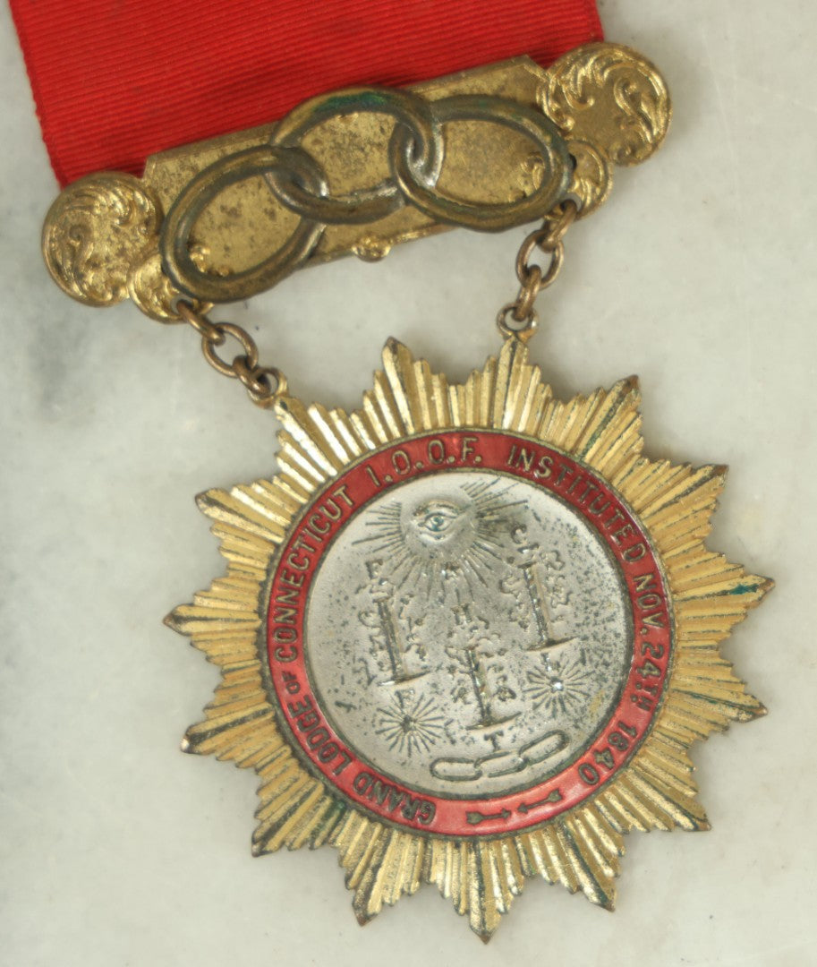 Lot 055 - Antique Independent Order Of Odd Fellows I.O.O.F. Past Grand Master Red Ribbon And Badge, Grand Lodge Of Connecticut, By Whitehead And Hoag Co., Newark, New Jersey