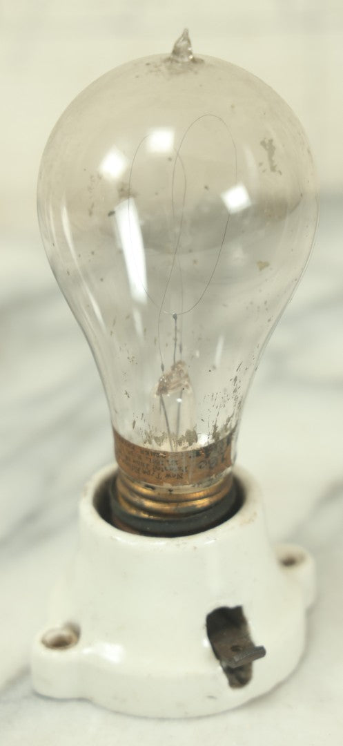 Lot 056 - Antique New Type Edison Lamp Light Bulb, Latest Patent Date September 1882, On Simple Porcelain Fixture, As Found, Untested, With Paper Label