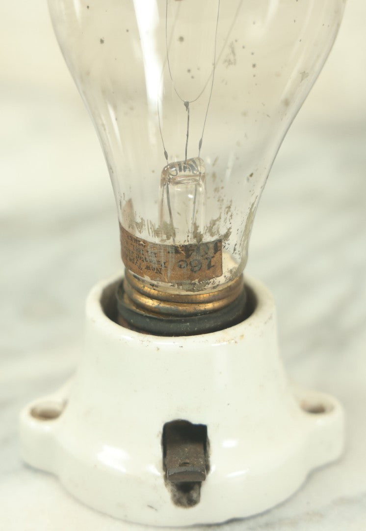 Lot 056 - Antique New Type Edison Lamp Light Bulb, Latest Patent Date September 1882, On Simple Porcelain Fixture, As Found, Untested, With Paper Label