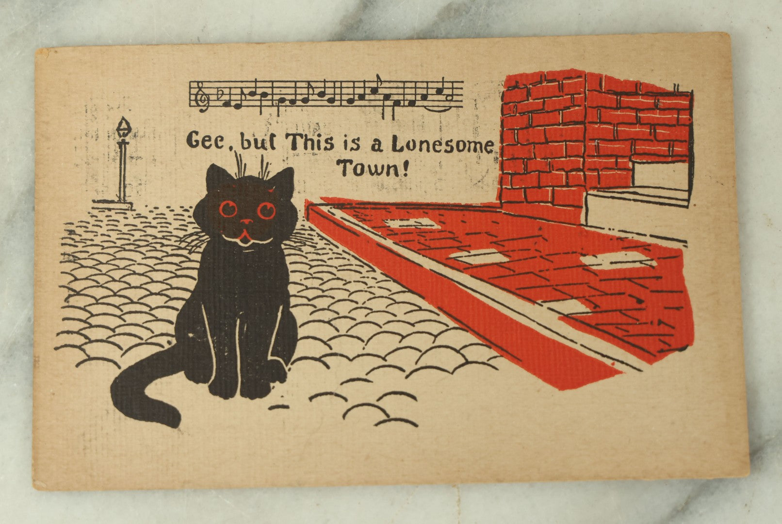 Lot 080 - Single Antique Cat Postcard, Black Cat On Cobblestone Street, "Gee This Sure Is A Lonesome Town"