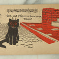Lot 080 - Single Antique Cat Postcard, Black Cat On Cobblestone Street, "Gee This Sure Is A Lonesome Town"