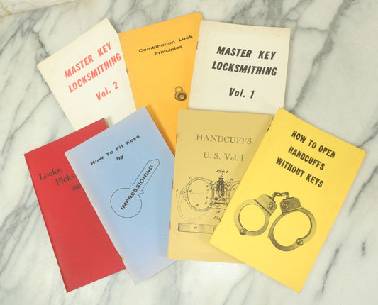 Lot 094 - Grouping Of Seven Booklets On Handcuffs And Locksmithing, Including How To Open Handcuffs Without Keys, Lock Picking, Etc., By Desert Publications, Late 1970s